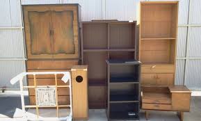 assorted furniture collected for dumping including cupboards